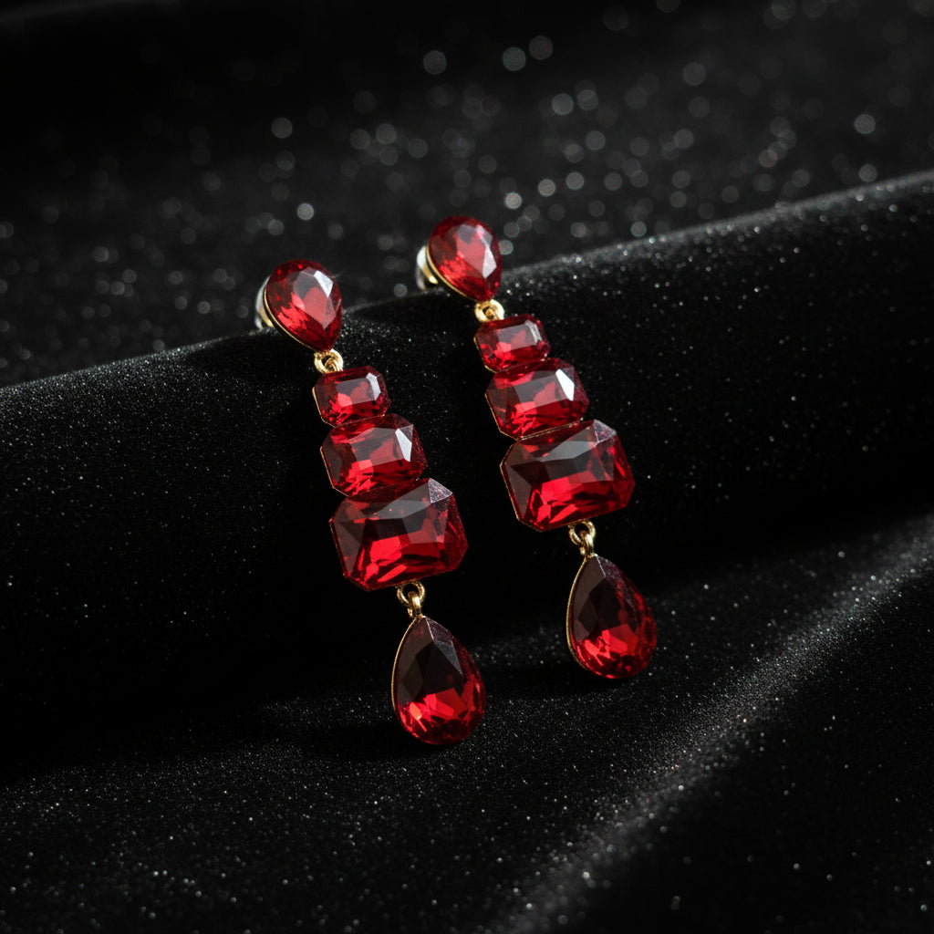 Red gemstone earrings on a gray background