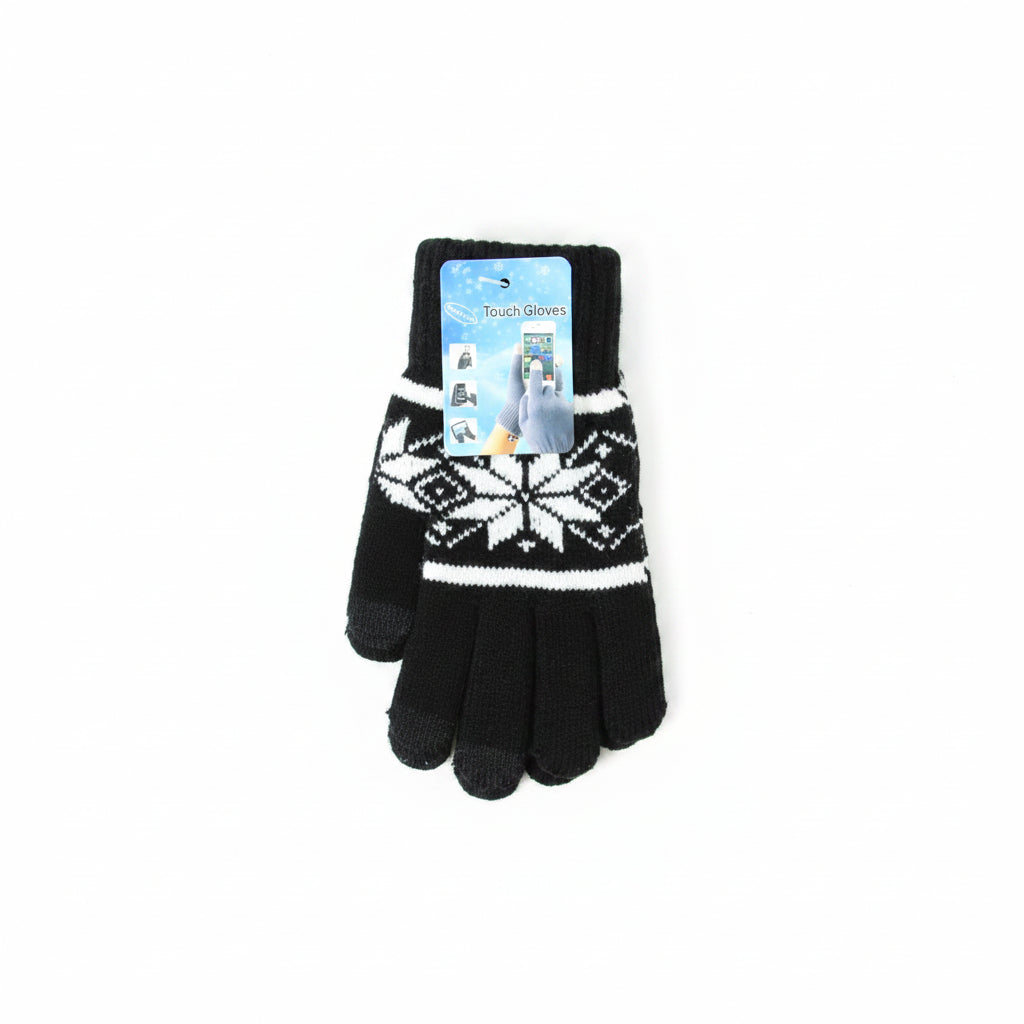 A single black knit winter glove with a white Nordic snowflake pattern and a blue printed hangtag, laid flat on a light wood floor.