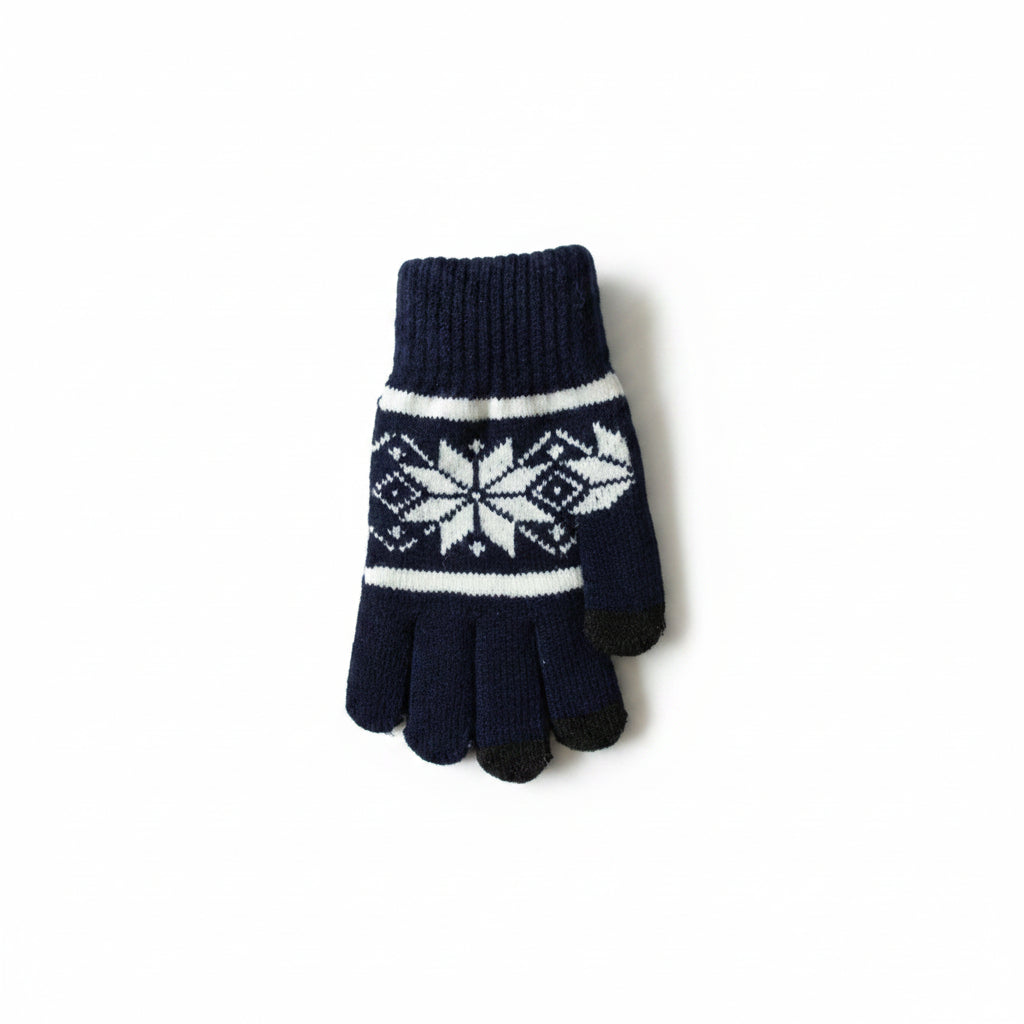 A single knit glove in dark navy blue with a white snowflake pattern and white stripes, resting on a light wood floor.