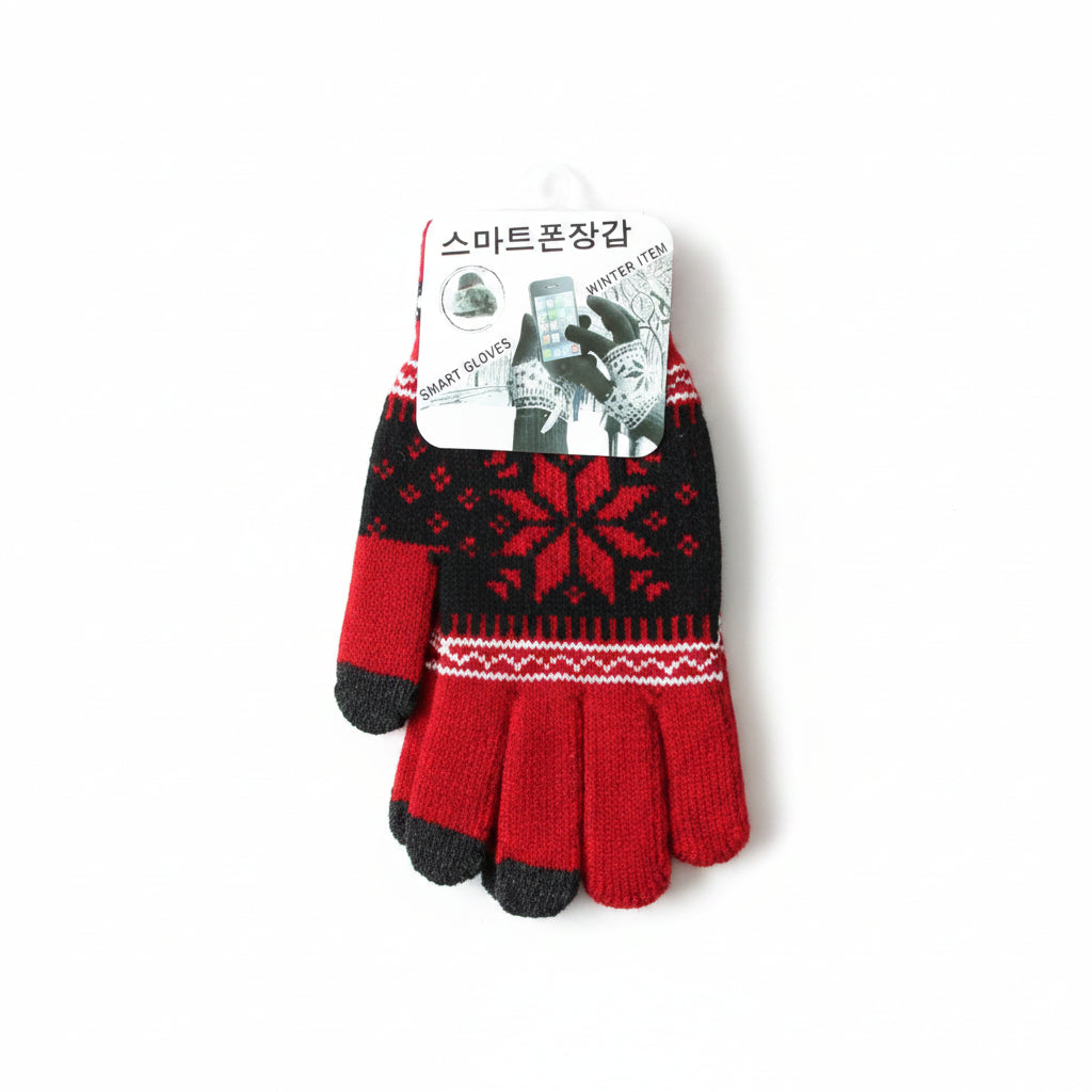 A single knit winter glove with a red and black Nordic snowflake pattern, featuring red fingertips and thumb sections with black tips, resting on a light wood floor with its retail tag attached.