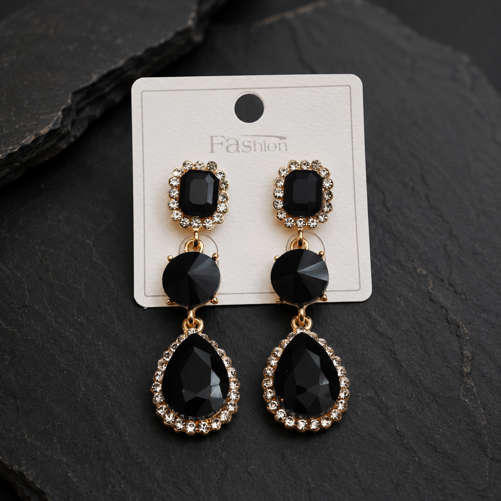 Black teardrop earrings with gold accents on a 'Fashion' branded card against a dark background