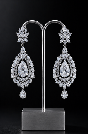 Pair of cubic zirconia earrings on a stand against a black background